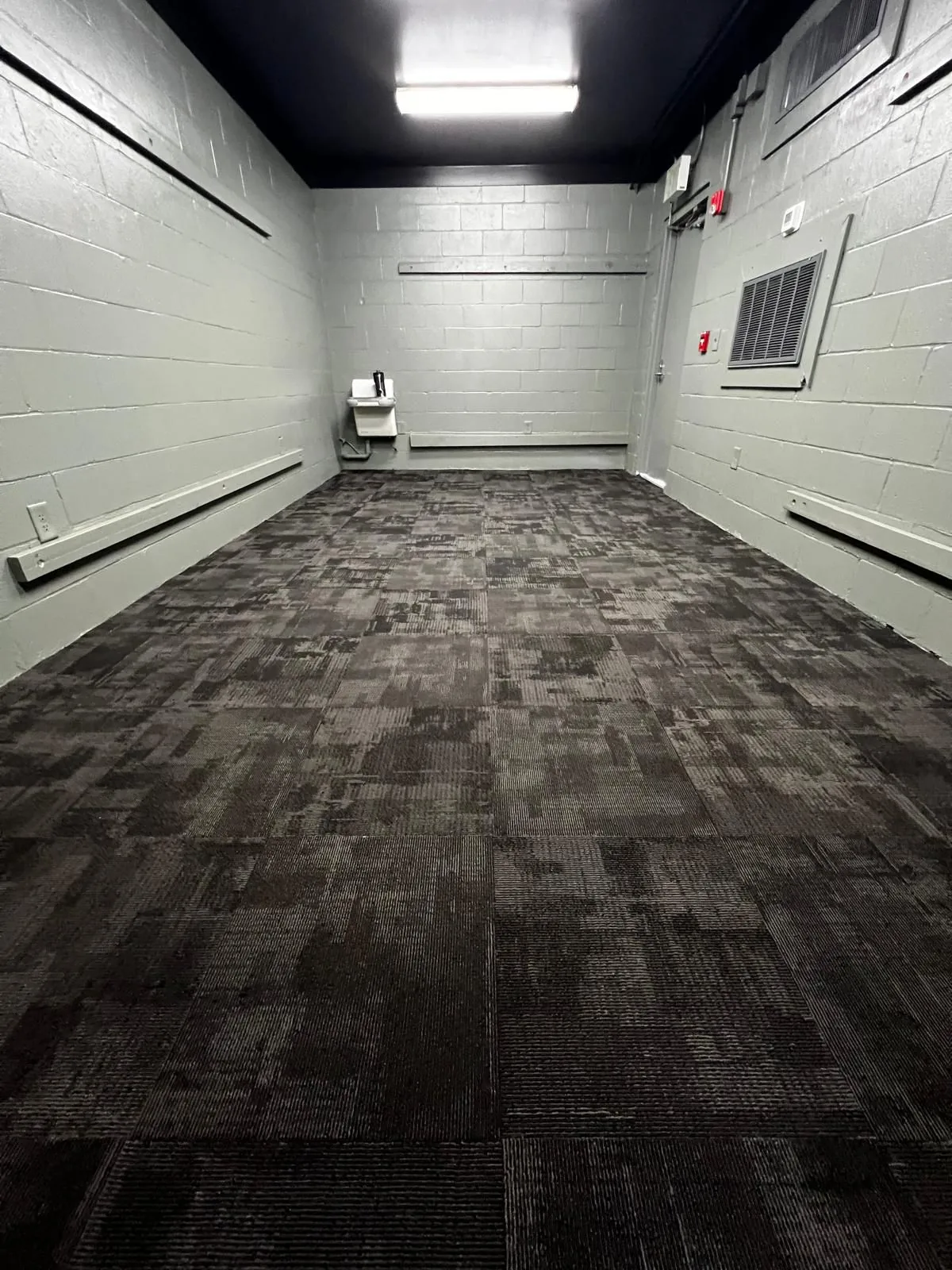 Dark carpet tile installed across a commercial room